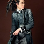 A man with a steampunk outfit and braded hair