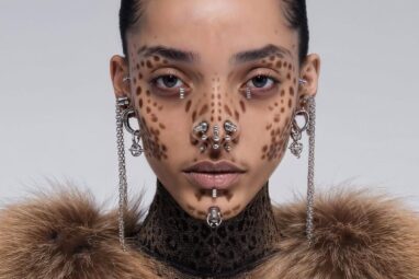 Portrait of female middle eastern AI model with silver piercings in nose area, ears and chin. Face covered by brown animal pattern face paint. Fur coat. AI fashion editorial.