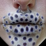 Lips covered by blue dotted fur. Ear and lip piercings in the style of AI editorial